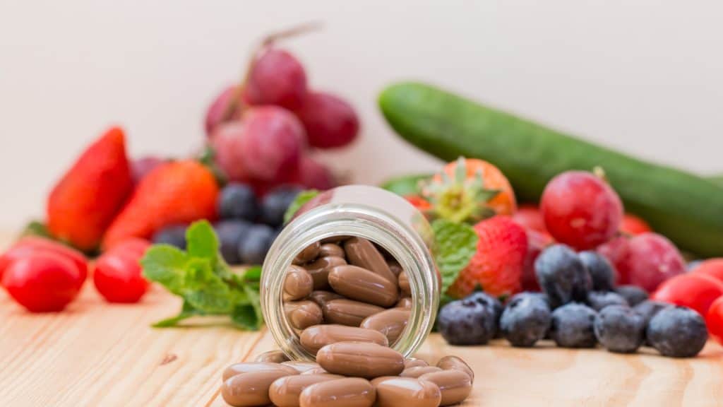 a jar of pills spilling out of a glass jar