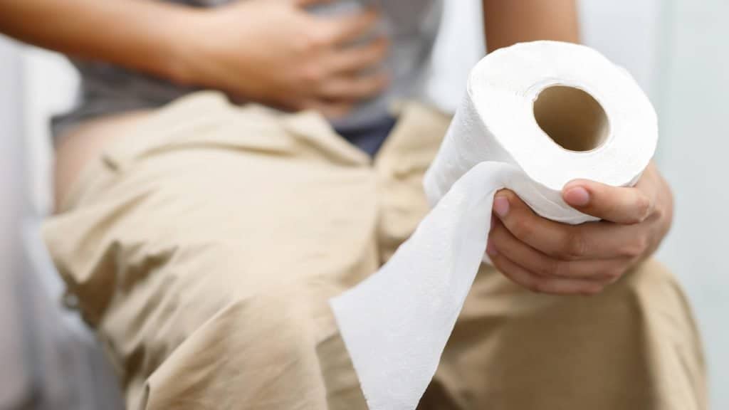 a person holding a roll of toilet paper