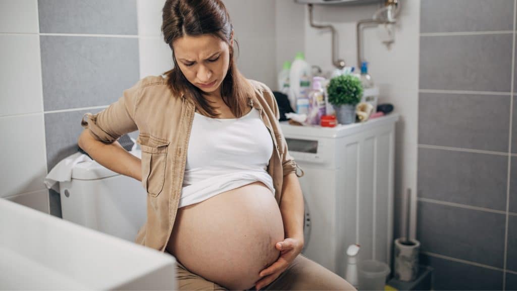 a pregnant woman holding her belly