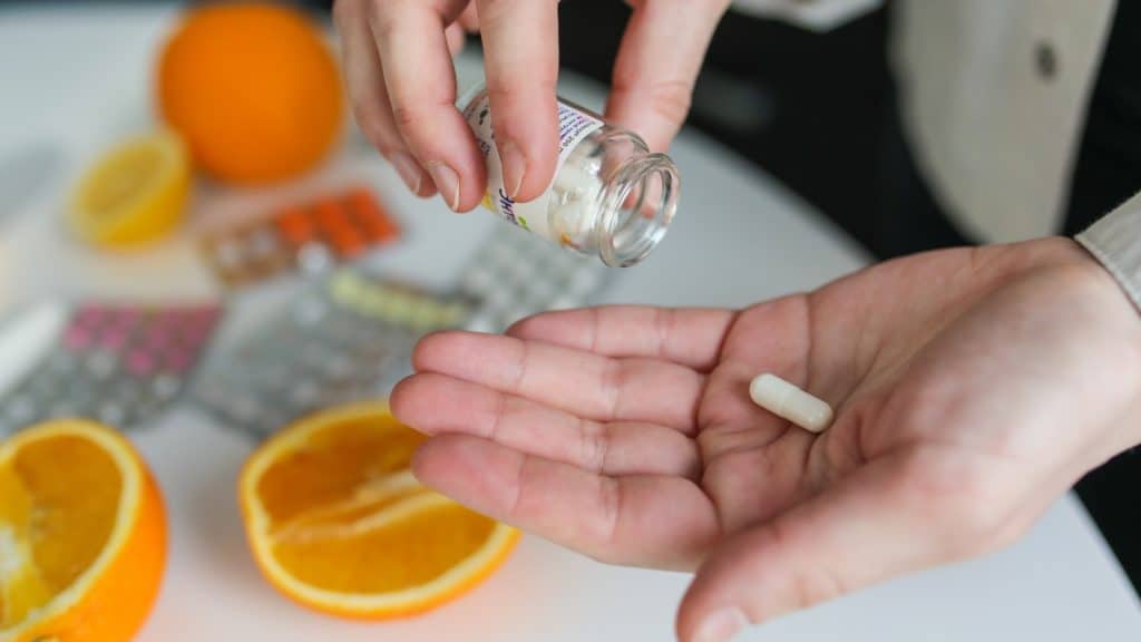 a person holding a pill in their hand