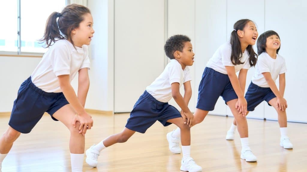 Children stretching in a classroom setting.